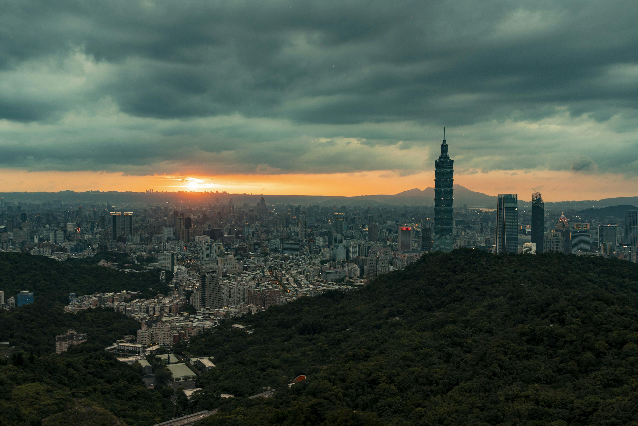 Capture of Taipei at sunrise, featuring dramatic skies and iconic skyscrapers, including Taipei 101.